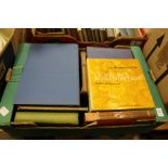 A box of art and antique reference books.