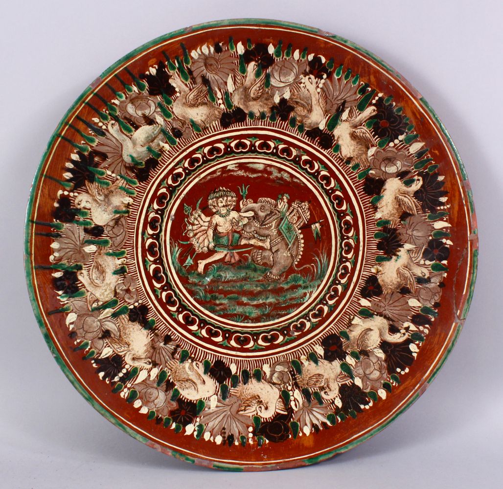 A 19TH CENTURY OR EARLIER INDIAN POTTERY DISH, with poly chrome decoration depicting a multi