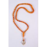 A FINE SET OF 19TH CENTURY QING DYNASTY CARVED AMBER BEAD NECKLACE / ROSARY BEADS, comprising 101