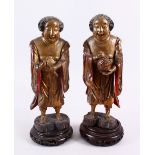 A PAIR OF 19TH CENTURY CHINESE CARVED WOOD AND LACQUER IMMORTAL FIGURES, each stood holding