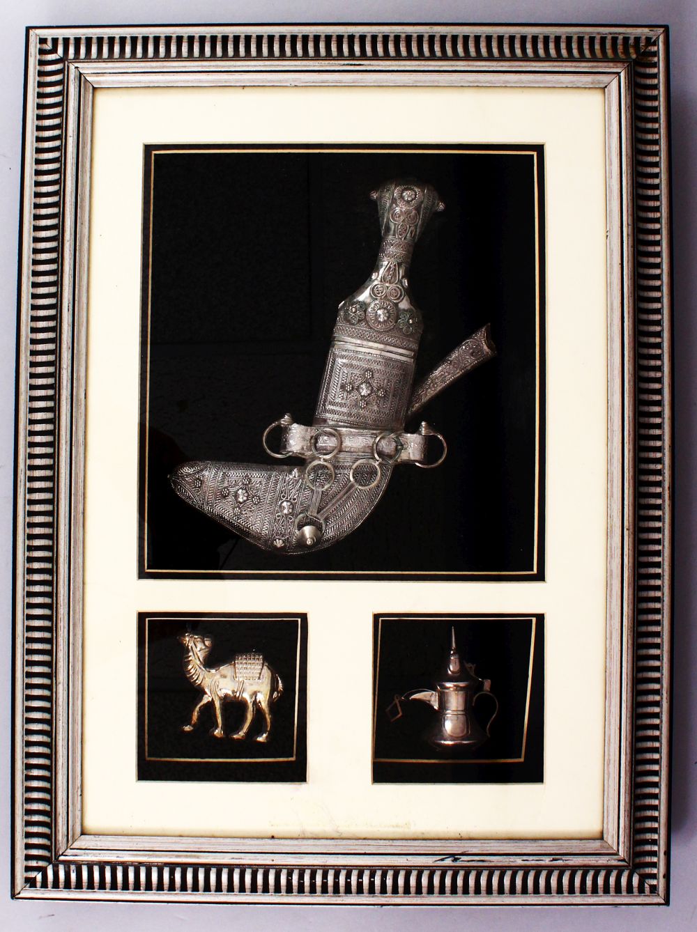 A GOOD 19TH CENTURY TURKISH KINJAL DAGGER IN A FRAME WITH A CAMEL AND OIL POURER, white metal,