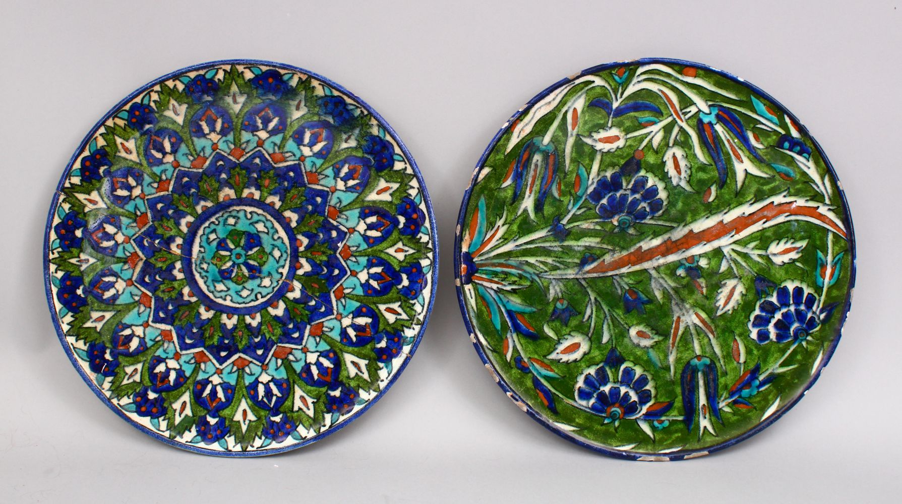 TWO LARGE JERUSALEM PALESTINIAN POTTERY DISHES, Both with formal floral decoration, one af, both
