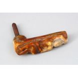 A CARVED BONE WALKING STICK HANDLE, carved with a nude, dated 1910.