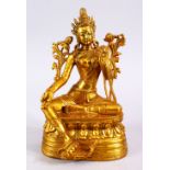 A CHINESE GILT BRONZE FIGURE OF BUDDHA, in a seated position with one hand aloft, seated on a