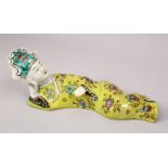 A CHINESE 19TH CENTURY FAMILLE ROSE PORCELAIN WALL HANGING FIGURE, depicting a recumbent lady,