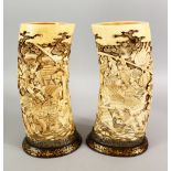 A FINE PAIR OF JAPANESE MEIJI PERIOD CARVED IVORY SAMURAI TUSK VASES, the vases finely and deeply