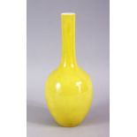A CHINESE YELLOW GROUND MONOCHROME PORCELAIN BOTTLE VASE, the base with a six character mark, 22cm.