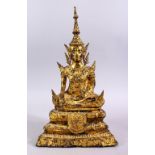 AN 18TH / 19TH CENTURY THAI GILT BRONZE FIGURE OF BUDDHA, seated in meditation upon lotus formed