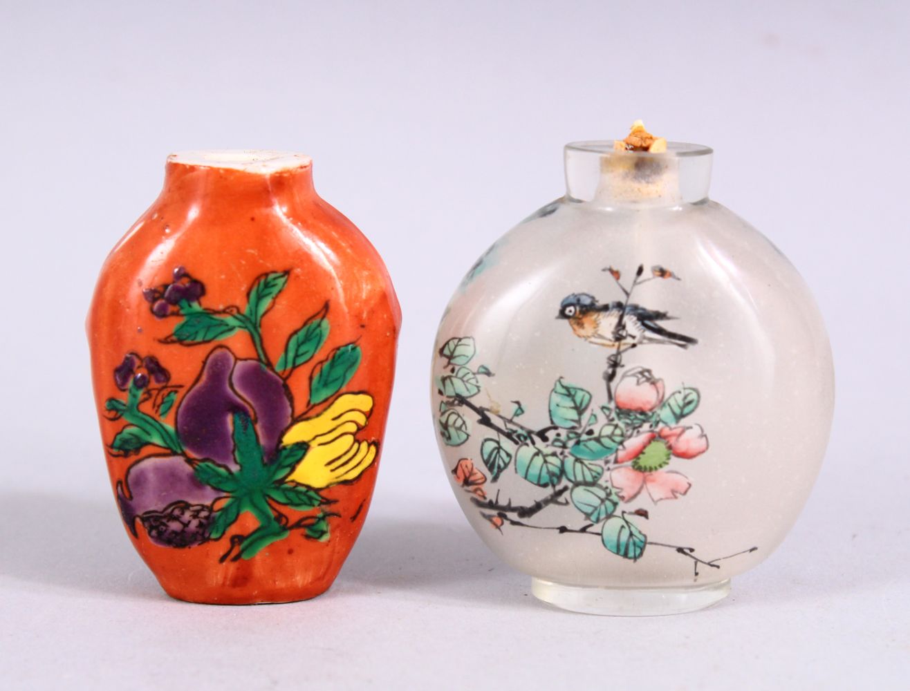 TWO 19TH / 20TH CENTURY CHINESE SNUFF BOTTLES, one porcelain with coral ground and decoration of