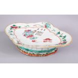 A CHINESE 19TH CENTURY FAMILLE ROSE PORCELAIN FOOTED DISH, depicting a seated figure amongst flora