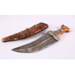 A 19TH CENTURY ARAB JAMBIYA DAGGER WITH AMBER COLOUR BAKELITE HILT, with a leather scabbard, and