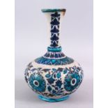 A 19TH CENTURY OR EARLIER PERSIAN POTTERY BOTTLE VASE, decorated with formal floral motif, 25cm, (