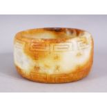 A CHINESE CARVED SOAPSTONE BANGLE, carved in archaic form, 11cm.