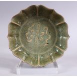 A CHINESE SONG STYLE CRACKLE GLAZED PORCELAIN DISH, with raised precious object decoration, the base