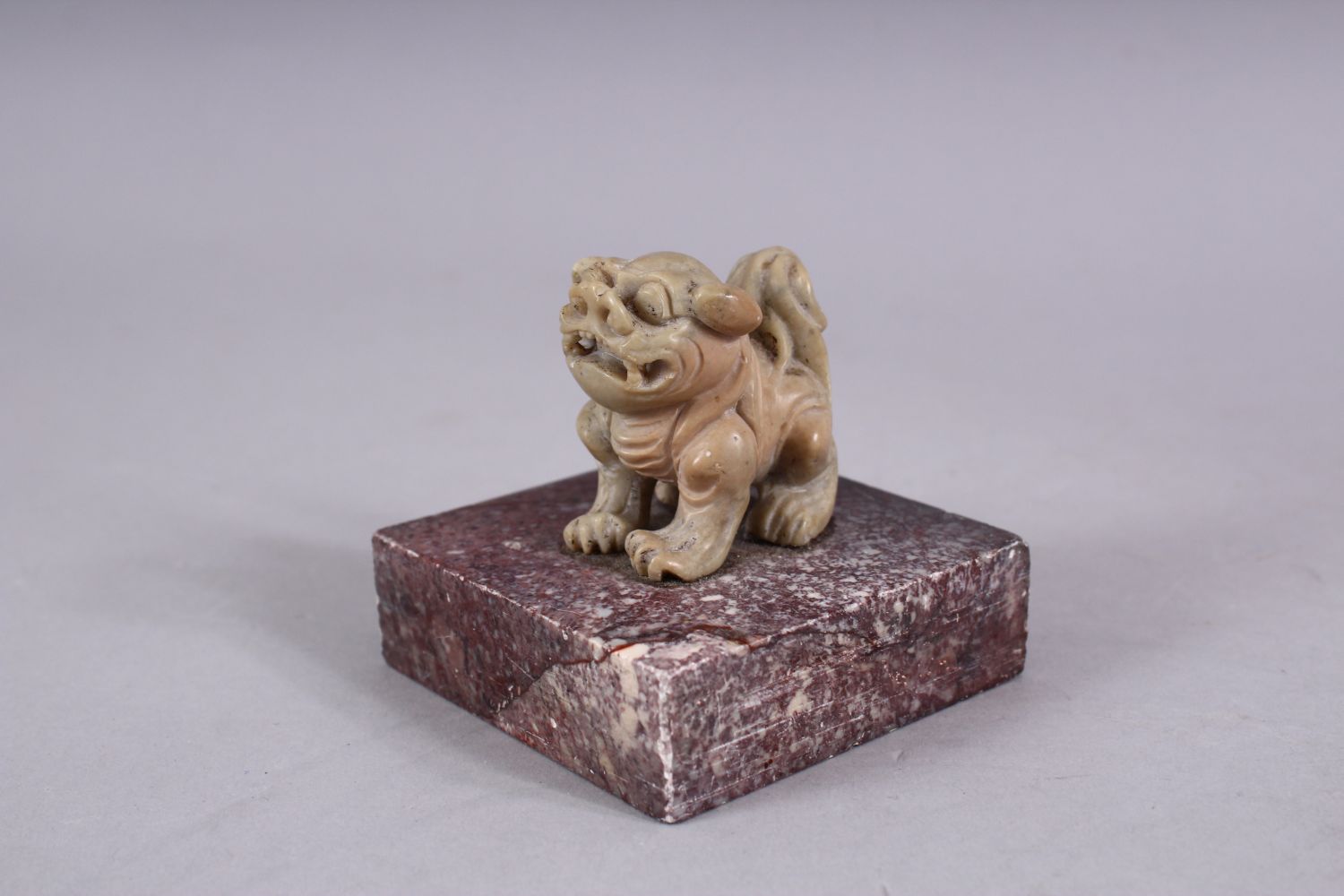 A CHINESE 19TH / 20TH CENTURY CARVED SOAPSTONE LION DOG SEAL, the dog upon plinth, the base cared - Image 2 of 3
