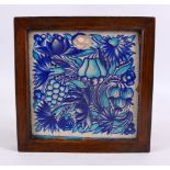 A GOOD FRAMED TURKISH POTTERY TILE, decorated with two tone blue fruit and vine decoration, 23cm