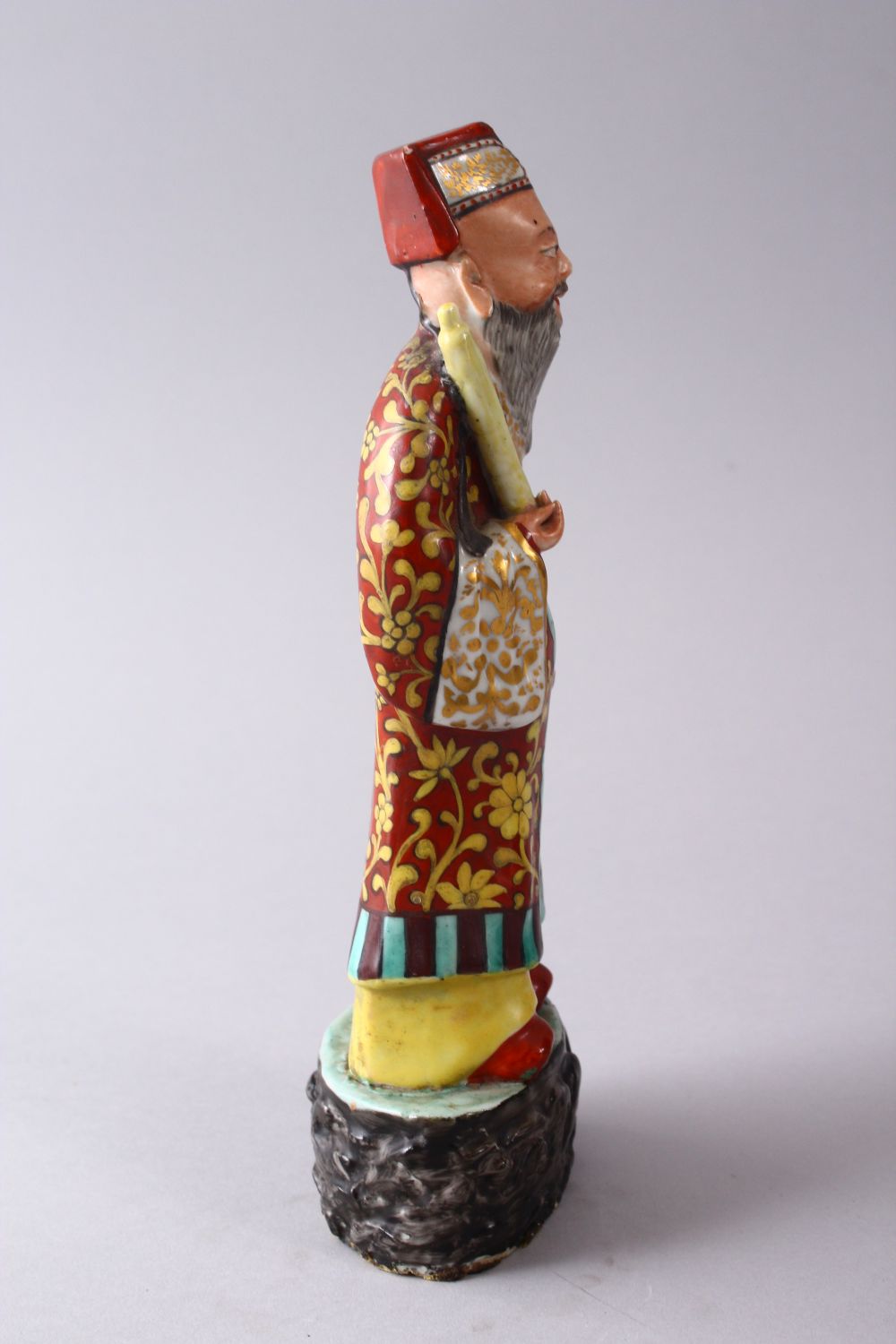 A CHINESE FAMILLE ROSE POTTERY FIGURE OF A SCHOLAR, holding a scroll upon a stylized base, 22cm - Image 2 of 5