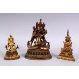 THREE TIBETAN GILT BRONZE FIGURES, each with varying pose, the smallest with poly chrome decoration,