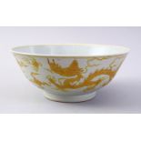 A CHINESE YELLOW INCISED PORCELAIN DRAGON BOWL, the base with a six character mark to base, 19cm.