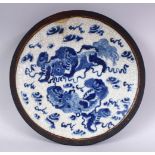 A CHINESE BLUE & WHITE CRACKLE GLAZED PORCELAIN LION DOG PLATE, decorated with two lion dogs amongst