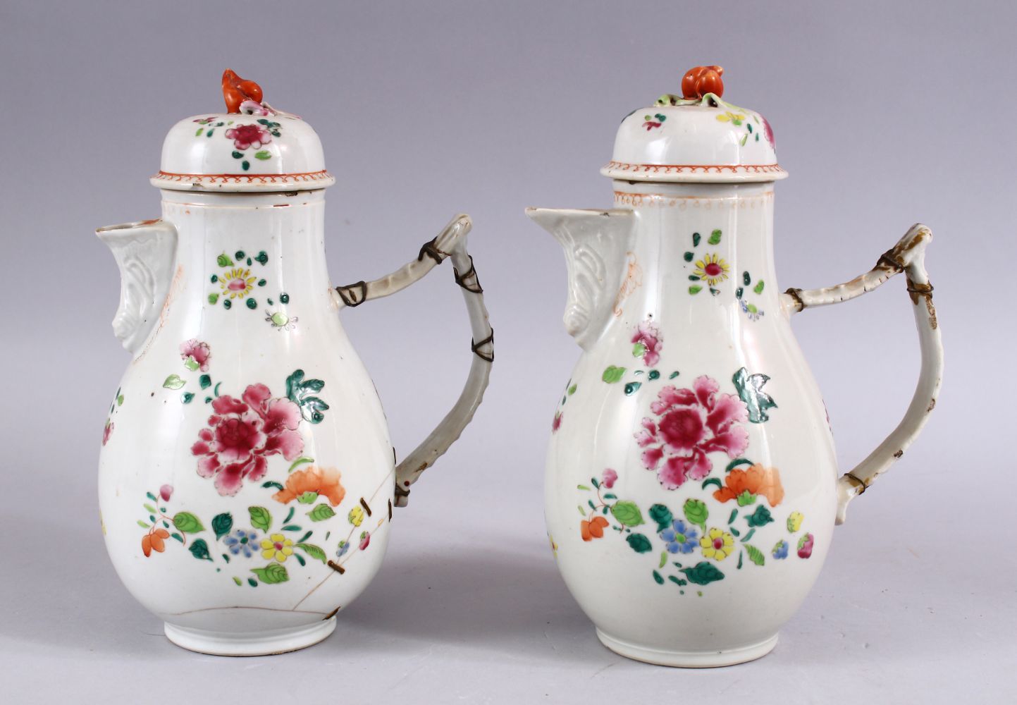 A PAIR OF 18TH CENTURY CHINESE FAMILLE ROSE PORCELAIN COFFEE POTS & COVERS, both decorated with