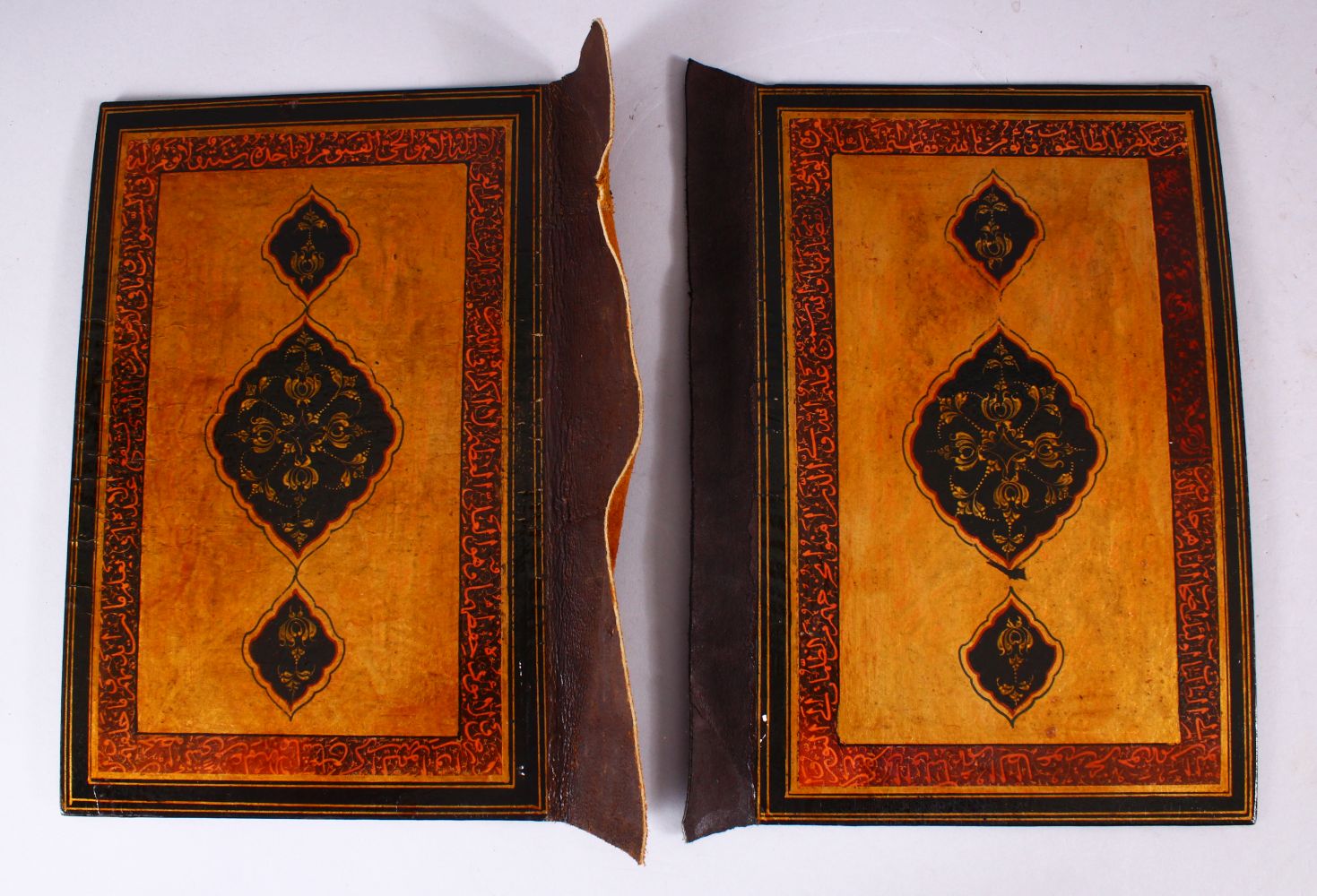 A GOOD 19TH CENTURY PERSIAN LACQUER BOOK COVERS, painted with bands of calligraphy and floral