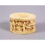 A CHINESE CANTON CARVED IVORY NAPKIN RING, carved with figures in landscapes, 5cm.