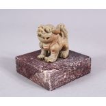 A CHINESE 19TH / 20TH CENTURY CARVED SOAPSTONE LION DOG SEAL, the dog upon plinth, the base cared