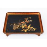 A GOOD JAPANESE MEIJI PERIOD LACQUER TRAY ON FEET, the tray decorated with scenes of native flora,