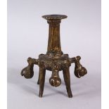 AN ISLAMIC BRONZE CANDLESTICK OR JOSS STICK HOLDER, on four feet with 5 ringing bells, 10cm high
