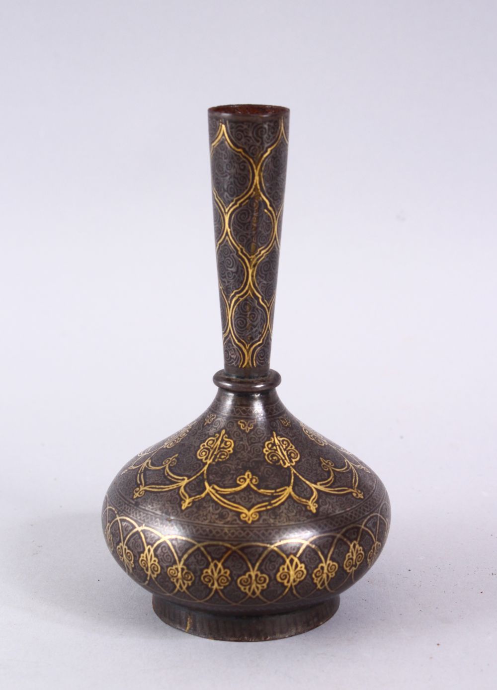 AN 18TH / 19TH CENTURY ISLAMIC GOLD INLAID STEEL VASE, the gold inlay with formal decoration, 13cm.