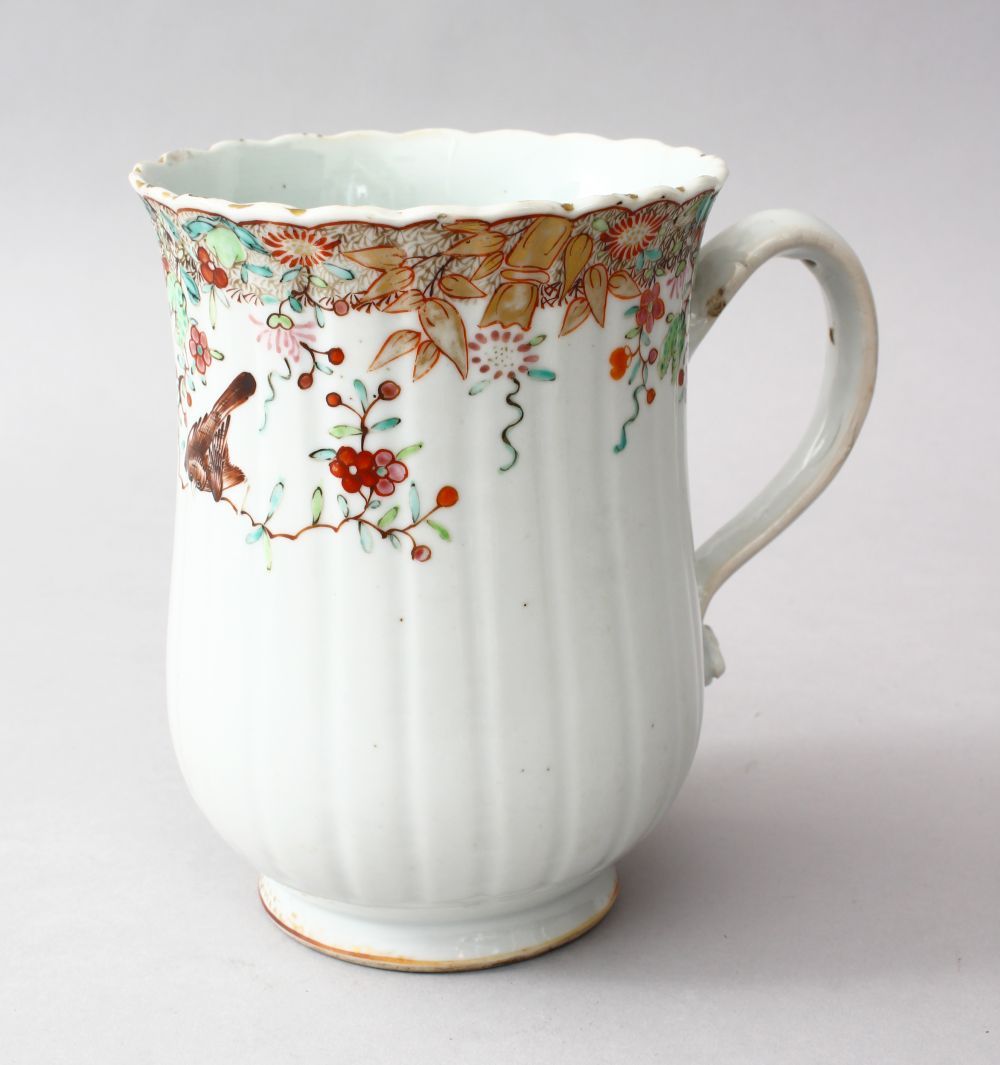 A GOOD 18TH CENTURY CHINESE QIANLONG FAMILLE ROSE PORCELAIN TANKARD, the body of the moulded tankard