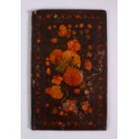A GOOD 19TH CENTURY PERSIAN LACQUER PAINTED BOOK COVER, depicting native floral spray, 20cm x 12cm