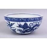 A LARGE CHINESE MING STYLE BLUE & WHITE DRAGON PORCELAIN BOWL, the bowl decorated interior with a