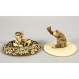 TWO JAPANESE MEIJI PERIOD CARVED IVORY TUSK VASE LIDS, one carved depicting a monkey holding a