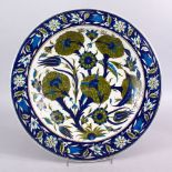 A TURKISH IZNIK FLORAL POTTERY PLATE, the body with floral motif decoration, 36cm.