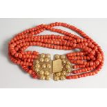 A SIX ROW CORAL BEAD NECKLACE WITH ORNATE 18CT GOLD CLASP. Approx. 14ins long.