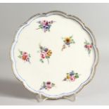 A SEVRES PEDESTAL TAZZA painted with flowers under a single blue line and dentil gilding,