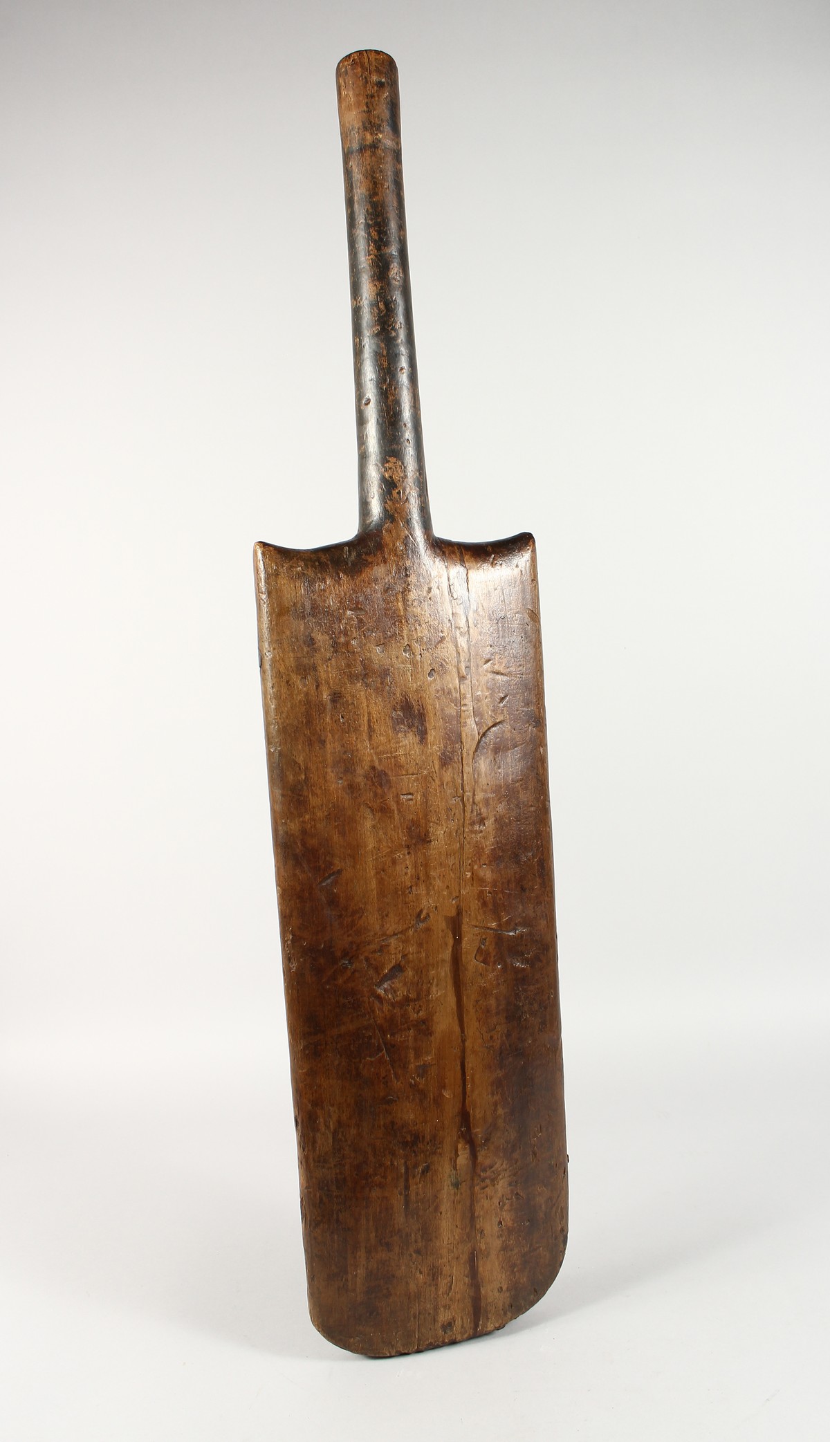 A LARGE EARLY FOLK ART CRICKET BAT. 34ins long.