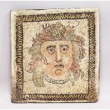 A SMALL RUSSIAN MOSAIC STONEWARE PANEL depicting a head. 1ft 9in x 1ft 8ins.
