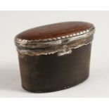 A GEORGE III OVAL HORN AND SILVER SNUFF BOX. 3ins long x 2ins high.