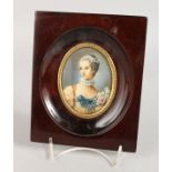 AN OVAL PORTRAIT MINIATURE OF A YOUNG LADY in a wooden frame. 3.25ins x 2.5ins. Signed.