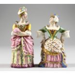 A RARE PAIR OF ANTIQUE MINTON CANDLE SNUFFERS of Mrs Malaprop and Lady Teazle. 3.5ins and 3.75ins