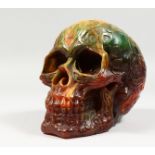 A RESIN MODEL OF A HUMAN SKULL. 7ins long.