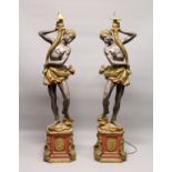 A PAIR OF PAINTED COMPOSITE BLACKAMOOR FLOOR STANDING SEVEN LIGHT CANDELABRA. 7ft 0ins high.