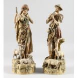 A PAIR OF ROYAL DUX SHEPHERD AND SHEPHERDESS with lambs and goats on rocky bases. Triangular mark.