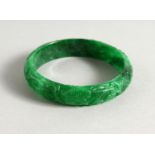 AN APPLE GREEN JADE BANGLE. 3ins diameter.