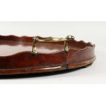 A GOOD GEORGIAN MAHOGANY OVAL TWO-HANDLED TRAY with brass waved rim. 26ins long.