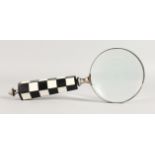 A MAGNIFYING GLASS.