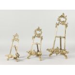 THREE DECORATIVE BRONZE EASELS. 8.5ins, 11ins and 16ins high.